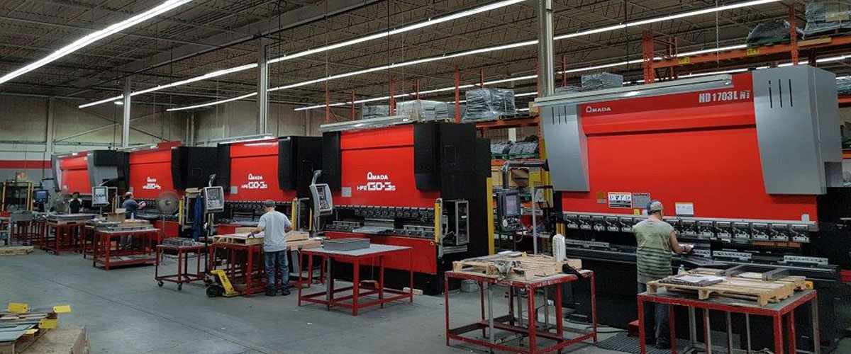 Image of the Dana Precision 41,000 Sq. Ft Manufacturing Facility, with employees working on metal fabrication machines.